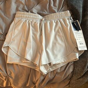 Running shorts with built in short liner and pocket